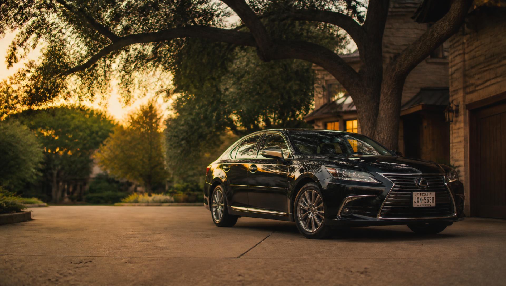 Mobile car detailer polishing a freshly detailed car in a Central Austin, TX driveway at golden hour